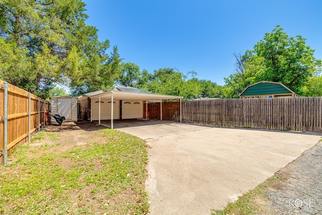 2713 Canyon Creek Dr, San Angelo, TX 76904 - view of side of home featuring a storage unit, an outbuilding, and a garage