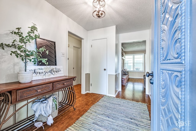 2713 Canyon Creek Dr, San Angelo, TX 76904 - entrance foyer featuring a textured ceiling, wood finished floors, and baseboards