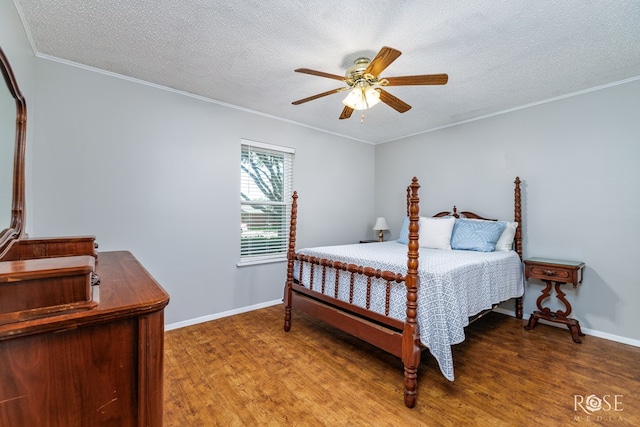 2713 Canyon Creek Dr, San Angelo, TX 76904 - bedroom featuring wood finished floors, a textured ceiling, crown molding, baseboards, and a ceiling fan