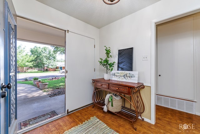 2713 Canyon Creek Dr, San Angelo, TX 76904 - foyer featuring wood finished floors, a textured ceiling, and baseboards