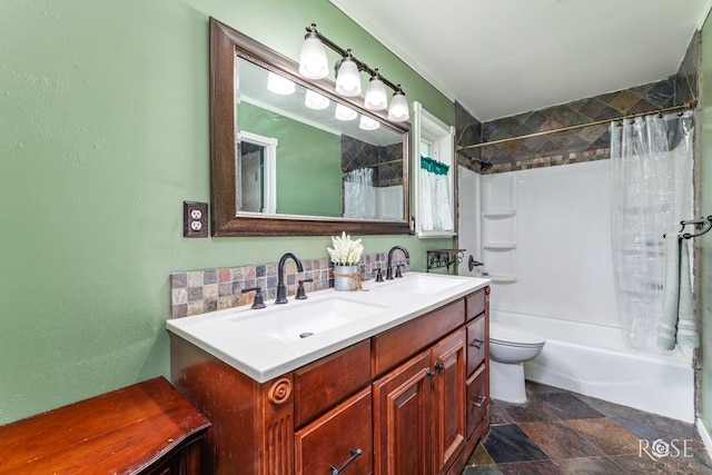 2713 Canyon Creek Dr, San Angelo, TX 76904 - full bath with shower / bathtub combination with curtain, double vanity, toilet, stone finish floors, and a textured wall