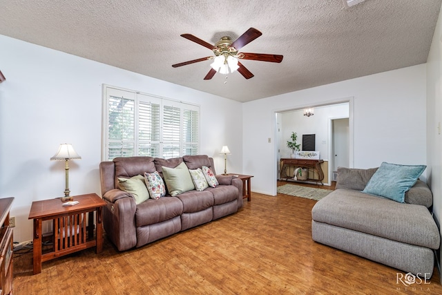 2713 Canyon Creek Dr, San Angelo, TX 76904 - living area with wood finished floors, a ceiling fan, and a textured ceiling