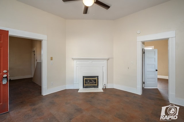 unfurnished living room featuring dark wood-type flooring and ceiling fan