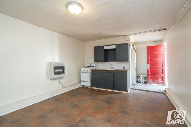 kitchen with sink, heating unit, and white gas stove