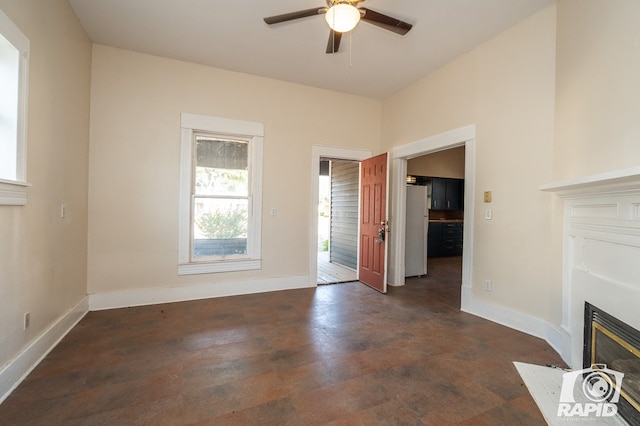 unfurnished living room with dark hardwood / wood-style floors and ceiling fan