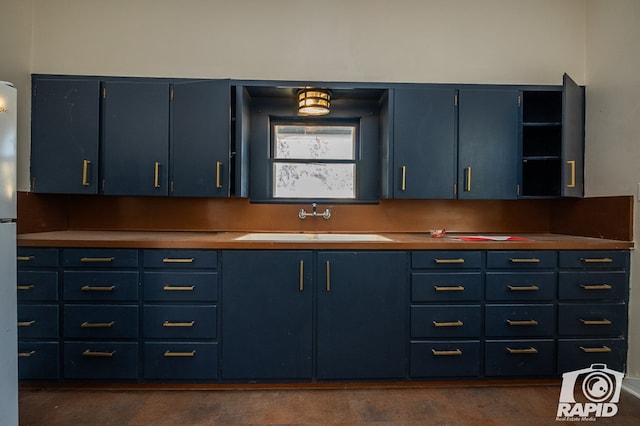 kitchen featuring blue cabinetry and sink