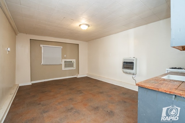 basement featuring heating unit and sink