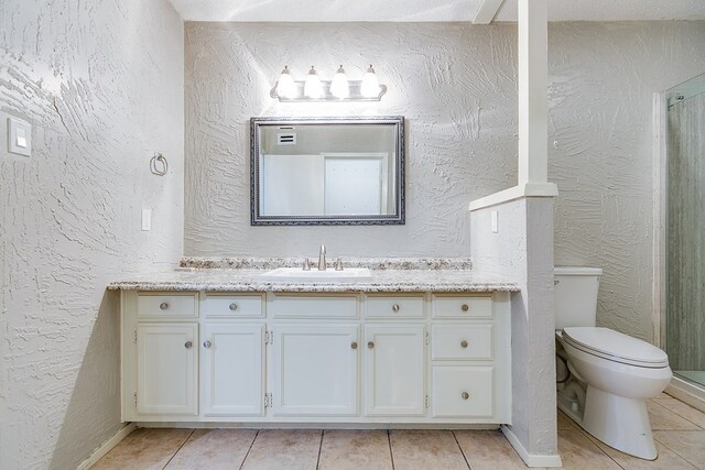 bathroom with vanity, tile patterned floors, and toilet