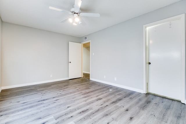 empty room featuring ceiling fan and light wood-type flooring