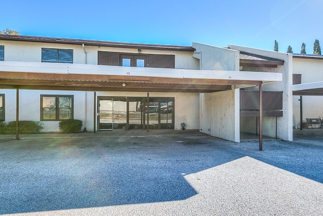 back of house with a carport