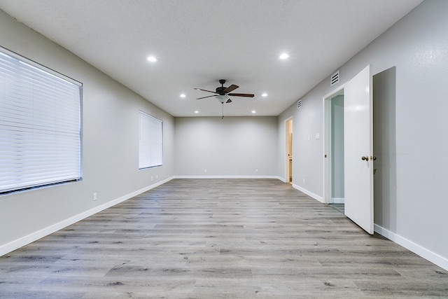 empty room featuring ceiling fan and light hardwood / wood-style floors