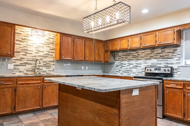 3329 Clearview Dr, San Angelo, TX 76904 - kitchen with stainless steel electric range oven, stone finish floors, brown cabinetry, backsplash, and a kitchen island