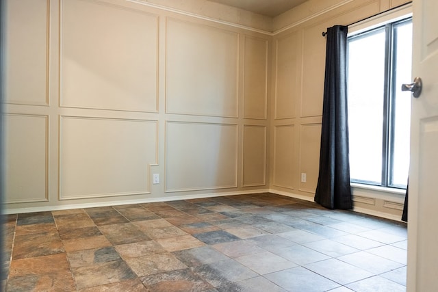 3329 Clearview Dr, San Angelo, TX 76904 - unfurnished room with a decorative wall and dark stone finish flooring