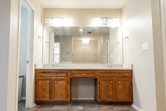 3329 Clearview Dr, San Angelo, TX 76904 - bathroom featuring double vanity, baseboards, and stone finish floors