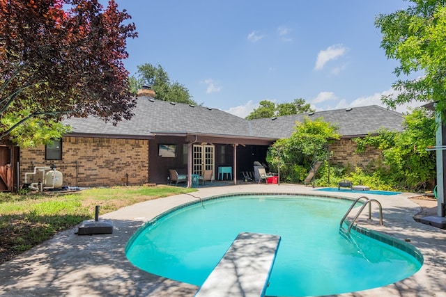 3329 Clearview Dr, San Angelo, TX 76904 - view of pool with a patio area, french doors, and a diving board