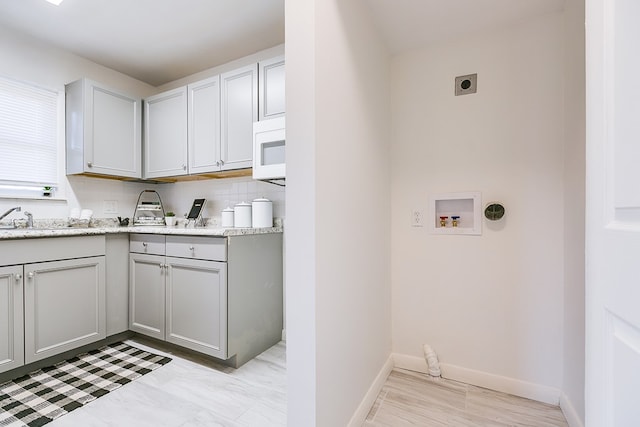 washroom with sink, hookup for a washing machine, and hookup for an electric dryer