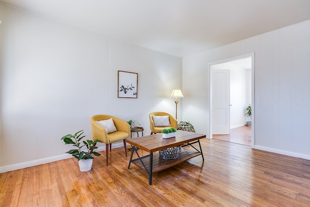 sitting room with wood-type flooring