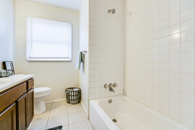 full bathroom featuring vanity, tile patterned flooring, tiled shower / bath combo, and toilet