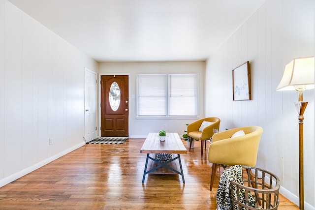 foyer entrance featuring hardwood / wood-style flooring and wood walls