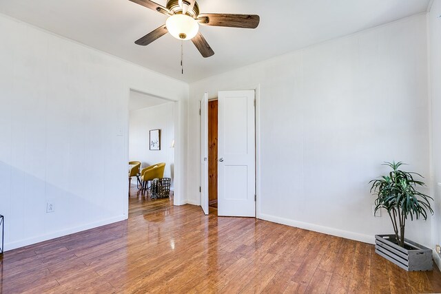 spare room with hardwood / wood-style flooring and ceiling fan