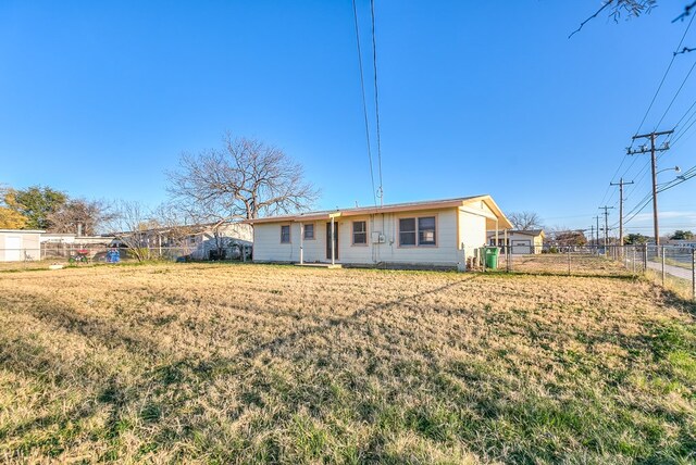 rear view of house featuring a yard