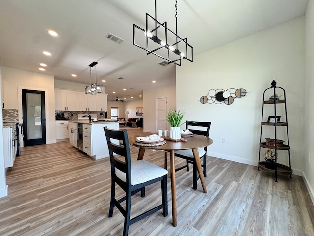 3634 Silver Spur Dr, San Angelo, TX 76904 - dining space featuring a chandelier, light wood-type flooring, recessed lighting, and baseboards