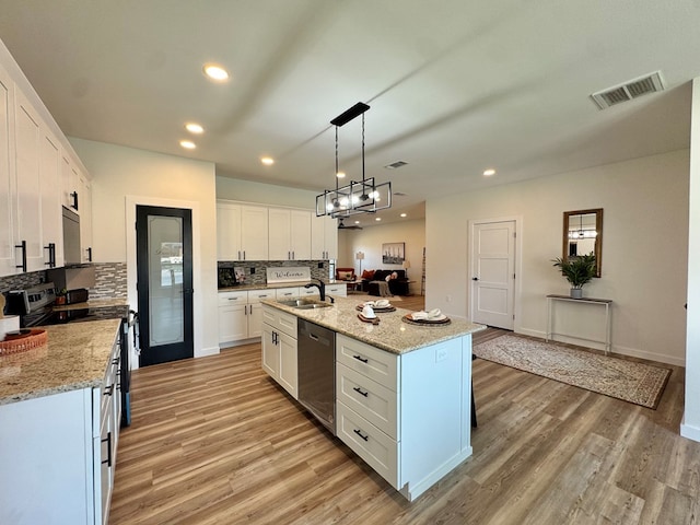 3634 Silver Spur Dr, San Angelo, TX 76904 - kitchen with stainless steel appliances, a sink, backsplash, light wood-style floors, and recessed lighting