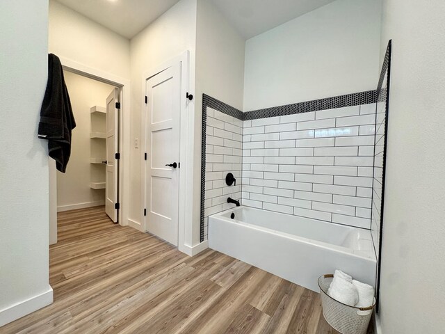 3634 Silver Spur Dr, San Angelo, TX 76904 - bathroom featuring wood finished floors, shower / washtub combination, and baseboards