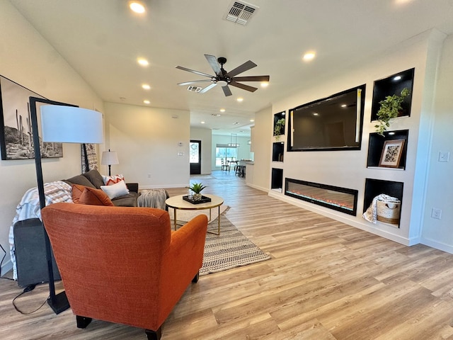 3634 Silver Spur Dr, San Angelo, TX 76904 - living area featuring a ceiling fan, light wood finished floors, a glass covered fireplace, recessed lighting, and baseboards