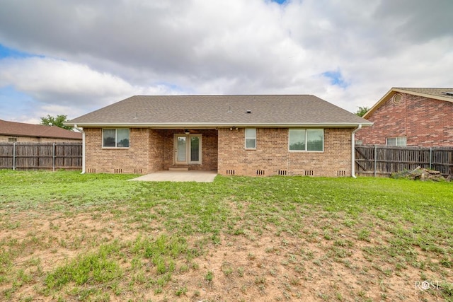 4506 Oak Grove Blvd, San Angelo, TX 76904 - back of property with a patio, brick siding, and a fenced backyard