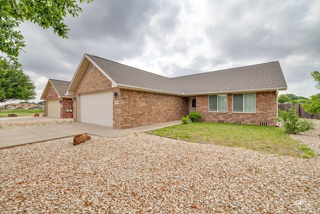 4506 Oak Grove Blvd, San Angelo, TX 76904 - ranch-style home with brick siding, a garage, roof with shingles, and fence