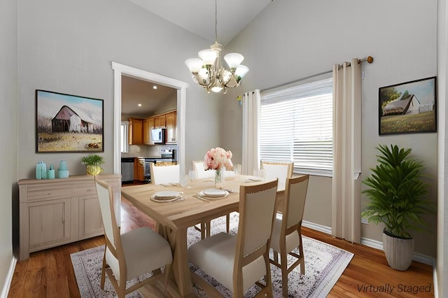 4506 Oak Grove Blvd, San Angelo, TX 76904 - dining area featuring an inviting chandelier, light wood finished floors, baseboards, and high vaulted ceiling