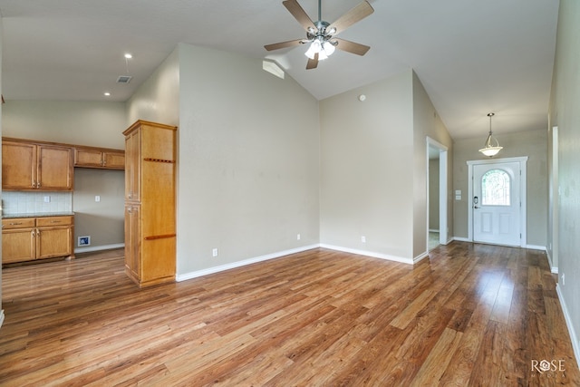 4506 Oak Grove Blvd, San Angelo, TX 76904 - unfurnished living room featuring a ceiling fan, visible vents, light wood-type flooring, high vaulted ceiling, and baseboards