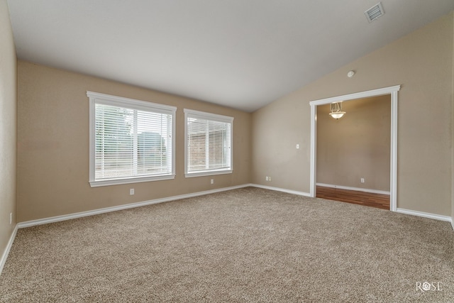 4506 Oak Grove Blvd, San Angelo, TX 76904 - unfurnished room featuring carpet floors, baseboards, vaulted ceiling, and visible vents