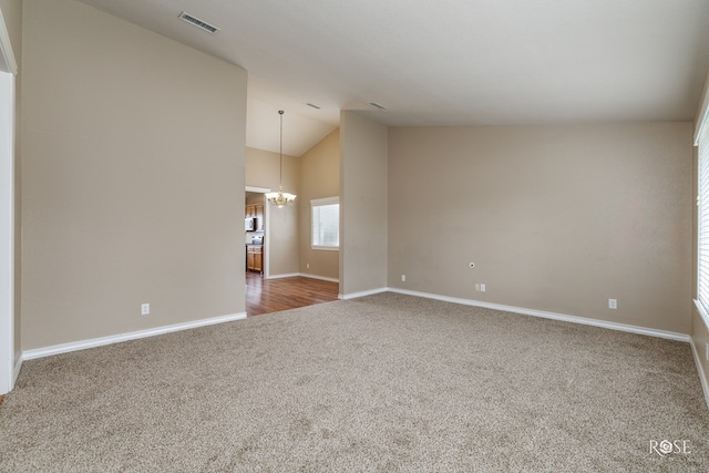 4506 Oak Grove Blvd, San Angelo, TX 76904 - carpeted empty room featuring baseboards, visible vents, high vaulted ceiling, and a chandelier