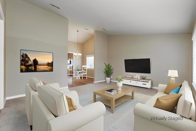 4506 Oak Grove Blvd, San Angelo, TX 76904 - carpeted living area featuring visible vents, baseboards, a notable chandelier, and high vaulted ceiling