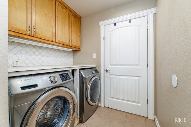 4506 Oak Grove Blvd, San Angelo, TX 76904 - laundry area featuring baseboards, washing machine and dryer, light tile patterned flooring, and cabinet space
