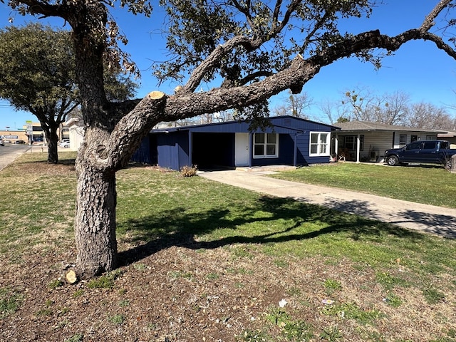 ranch-style house with a carport, concrete driveway, and a front yard