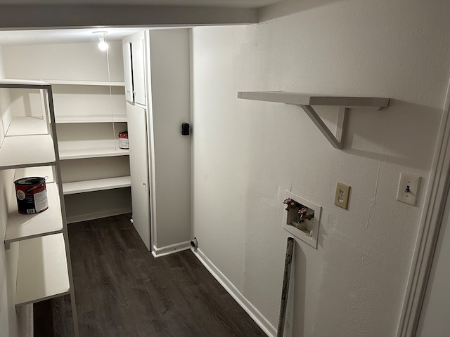 washroom featuring baseboards, washer hookup, laundry area, and dark wood-type flooring
