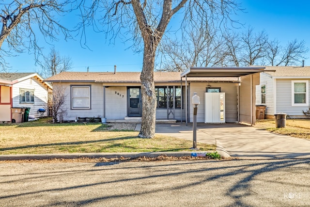 single story home with driveway, a front yard, and an attached carport