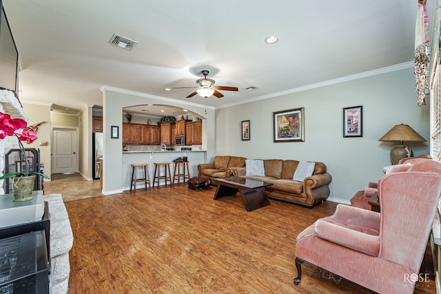 4641 Southland Blvd, San Angelo, TX 76904 - living area with crown molding, recessed lighting, ceiling fan, baseboards, and light wood finished floors