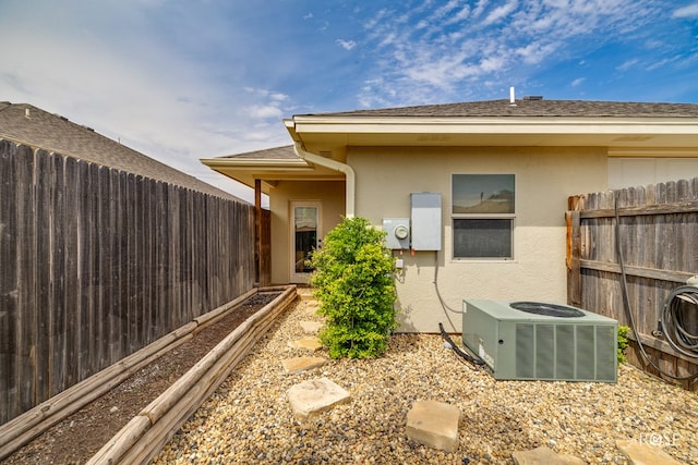 4641 Southland Blvd, San Angelo, TX 76904 - view of side of property with central AC unit, a fenced backyard, stucco siding, and a garden