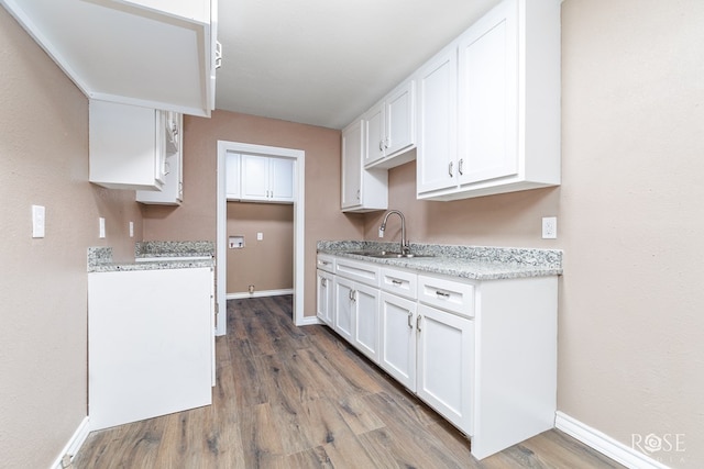 1611 Mission Ave, San Angelo, TX 76905 - kitchen featuring wood finished floors and white cabinetry