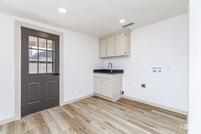 3853 Sandstone Rd, San Angelo, TX 76904 - washroom featuring hookup for a washing machine, hookup for an electric dryer, light wood-style flooring, cabinet space, and recessed lighting