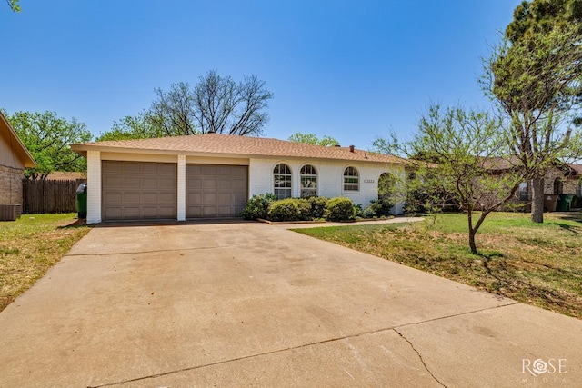 3853 Sandstone Rd, San Angelo, TX 76904 - view of front of home featuring a garage, concrete driveway, and brick siding