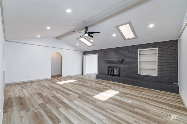 3853 Sandstone Rd, San Angelo, TX 76904 - unfurnished living room featuring a brick fireplace, a ceiling fan, wood finished floors, recessed lighting, and built in features