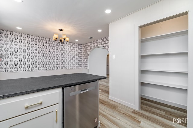 3853 Sandstone Rd, San Angelo, TX 76904 - kitchen featuring stainless steel dishwasher, arched walkways, dark countertops, recessed lighting, and a chandelier
