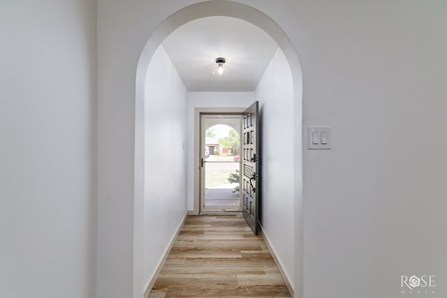 3853 Sandstone Rd, San Angelo, TX 76904 - hallway featuring arched walkways and light wood-type flooring