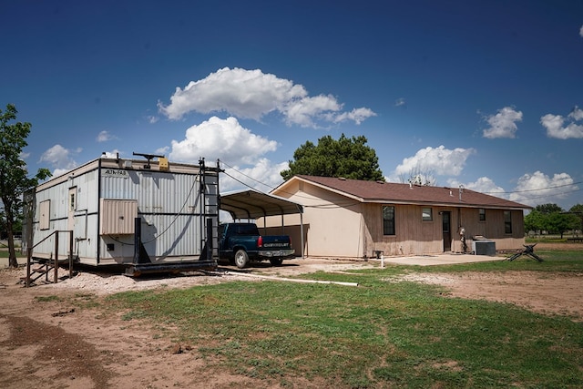 7229 Sun Ln, San Angelo, TX 76901 - rear view of property with a detached carport, central AC, and a yard
