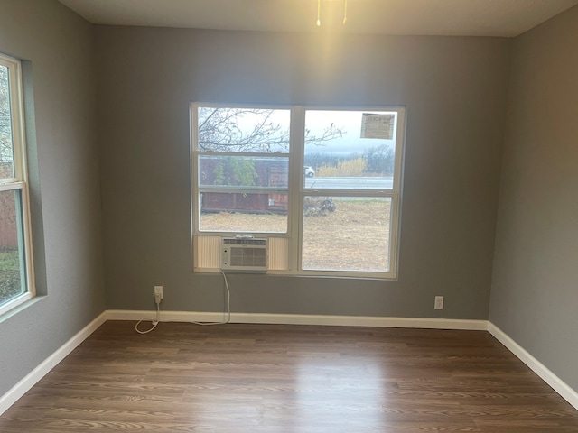 empty room with cooling unit and dark wood-type flooring